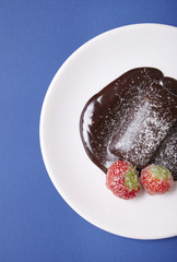 A hot chocolate fudge brownie dessert on a bright blue background