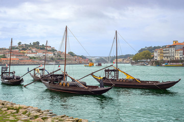 Fototapeta na wymiar Douro river rabelos boat detail Porto Oporto wine barrel historic cityscape embankment