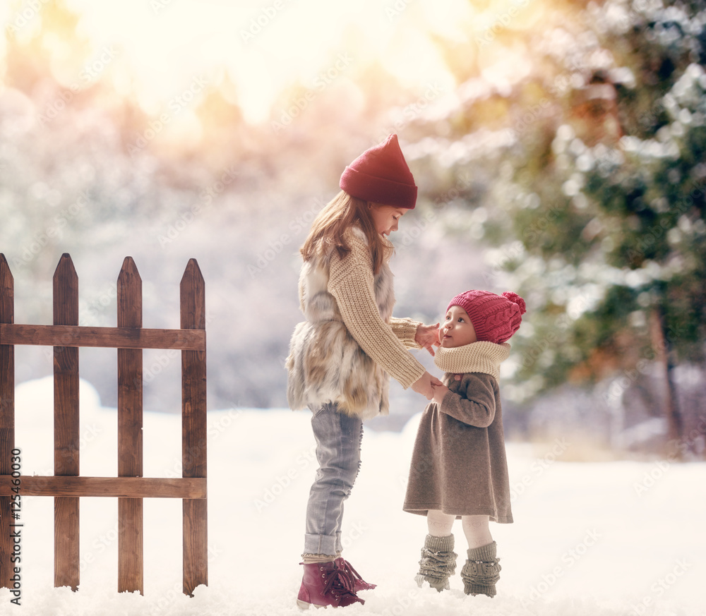 Poster girls playing on a winter walk