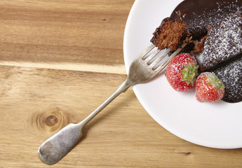 A chocolate fudge brownie dessert on a  wooden table background