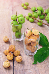 dried figs and fresh fruit on a wooden table. (ficus carica, ficus racemosa, ficus glomerata)