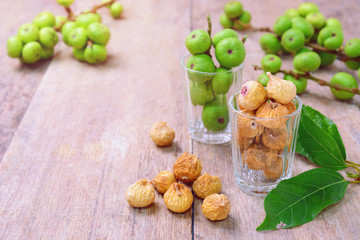 dried figs and fresh fruit on a wooden table. (ficus carica, ficus racemosa, ficus glomerata)