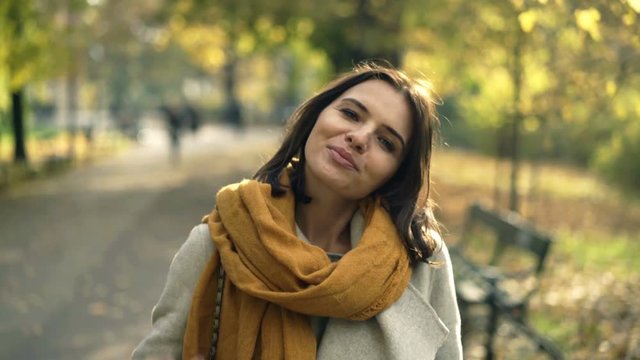 Portrait of happy, pretty woman in autumn park
