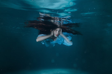Woman with long hair underwater.