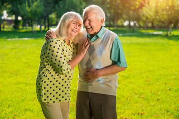 Senior couple is laughing. Man and woman outdoors. Funniest joke I've ever heard. Great mood for whole day.