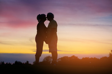 Couple standing on sky background. People touch noses. Save love and loyalty. Feels like heaven.