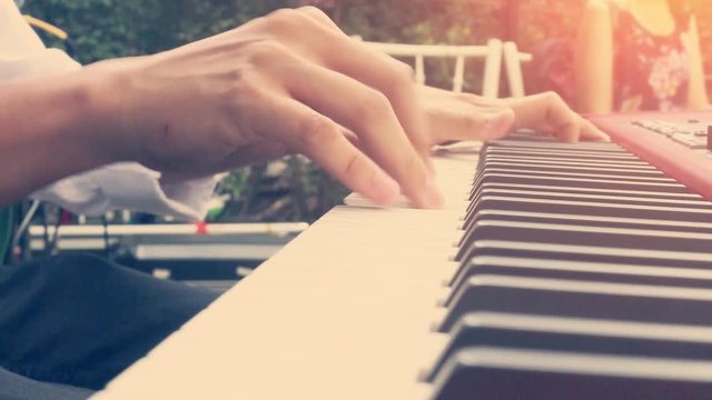 closeup of male hands playing piano. Man Playing the synthesizer keyboard.