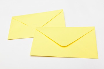 yellow letter envelopes on white backgrounds