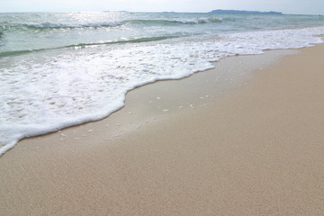 Wave of the sea on the sand beach background, Sea foam