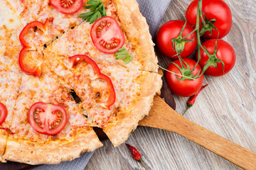 Hot pizza on wooden background