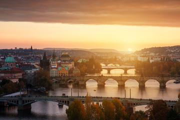 Fototapeta na wymiar Sunset landscape view to Charles bridge on Vltava river in Prague Czech republic in fall.