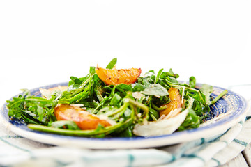 Vegetarian gourmet salad with arugula and peaches