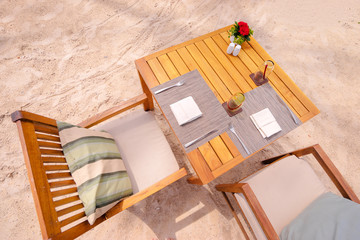 Table setting. Resort cafe on the sand beach. Top view.