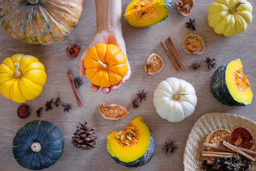 Collection of fresh pumpkins, papaya and melon on the wooden table. Top view.