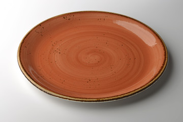 Rustic ocher plate isolated on white background