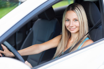 Young woman behind the steering wheel