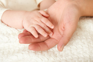 baby and mother hand closeup, happy maternity concept