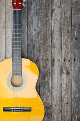brand new classical guitar on old wooden plank background