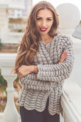 Pretty woman is wearing cozy knitted sweater