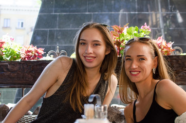 Two girlfriends sitting in the cafe