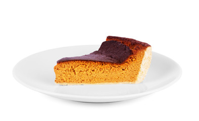 Piece of a pumpkin pie on a saucer isolated on white background