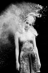 Graceful woman dancing in cloud of dust
