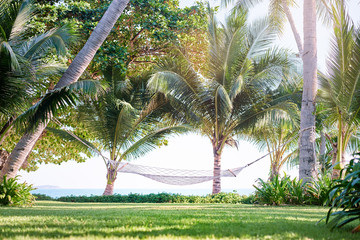 Vacation concept. Rope hammock near the sea beach.