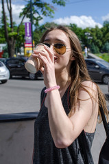 Young woman is drinking coffee 