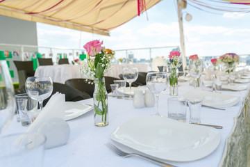 Set table decorated for wedding banquet on outdoor summer terrac