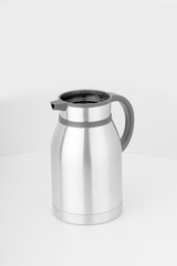Thermo or  flask from stainless stee on background