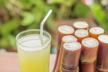 Sugarcane fresh juice for a detox diet - Organic fruits on woode