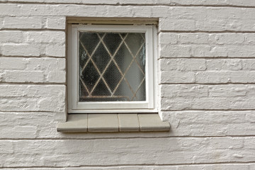Window Patterns and Texture of Cement Covered Brick Wall