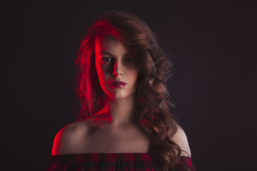 Woman with shadow on her face and red light