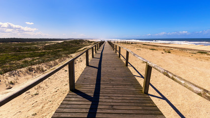 Fototapeta na wymiar Wooden track at Furadouro Beach, Ovar, Portugal
