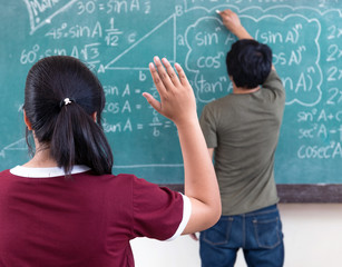 Raised hands in classroom at School