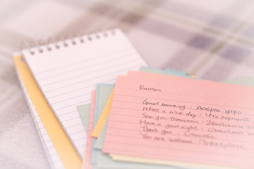 Fototapeta premium Russian; Learning New Language Writing Greetings on the Notebook