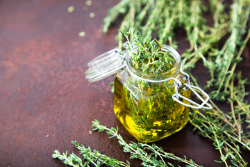 Thyme oil. Thyme essential oil jar glass bottle and branches of