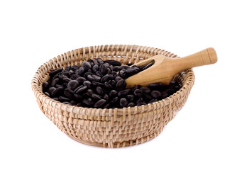 Fresh coffee beans in basket  with wooden scoop  isolated on whi