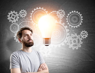 Bearded man and gears with ligth bulb