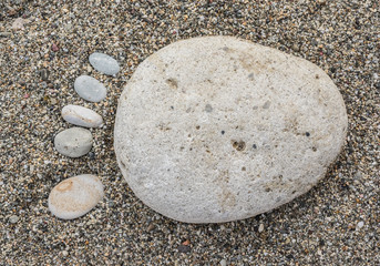 A foot made of pebble on a beach