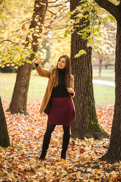 Woman taking selfie in the park