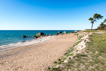 comfortable beach of the baltic sea with rocks and green vegetat