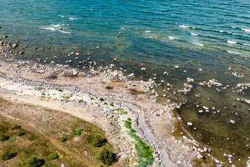 comfortable beach of the baltic sea with rocks and green vegetat