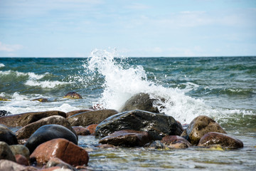 comfortable beach of the baltic sea with water crashing on the r