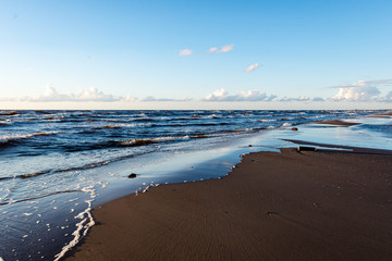 Fototapeta na wymiar comfortable beach of the baltic sea with rocks and green vegetat