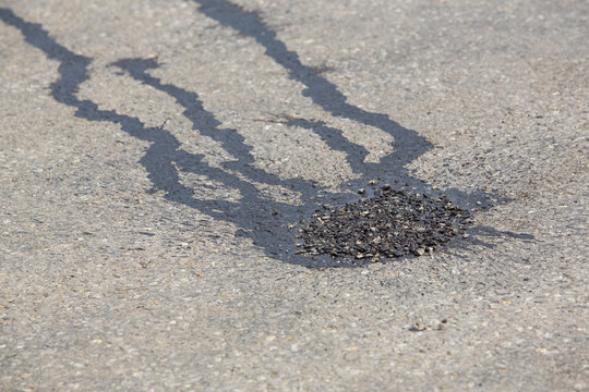 spot repairring the  road surface with asphalt