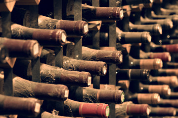 Bottles of wine aging in an underground cellar