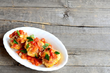 Homemade meatballs on a plate isolated on old wooden table. Meatballs prepared from minced meat and rice and braised in vegetable sauce. Traditional recipe. Vintage style