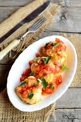 Delicious meatballs on a plate, fork, knife on old wooden table. Meatballs cooked from minced meat and rice and braised in vegetable sauce. Traditional dish. Vintage style