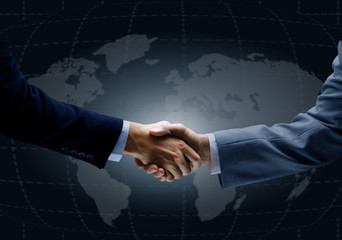 Handshake with map of the world in background